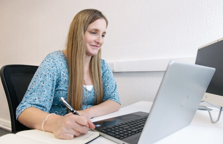 Modern legal workspace showing a lawyer working from home alongside office based colleagues, representing hybrid working in the legal sector
